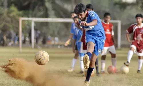Children playing football at a ground (Source: AFootball Report)