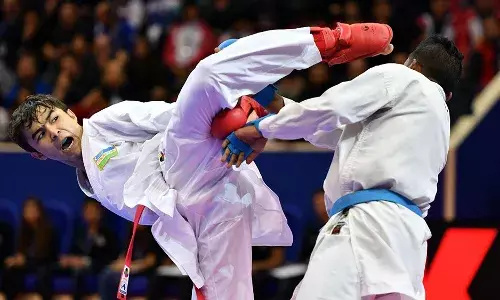 Two Karate players competing with each other