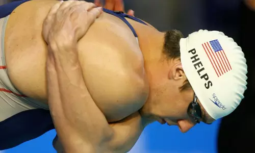 Why do swimmers slap their bodies before beginning a race