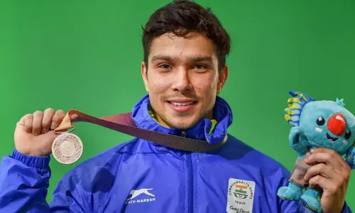 Indian Weightlifter Deepak Lather with his CWG medal. Indian Weightlifter Deepak Lather with his CWG medal.