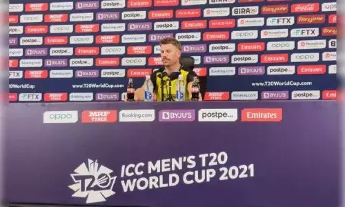 David Warner jokingly removes Coca Cola bottles at the press conference