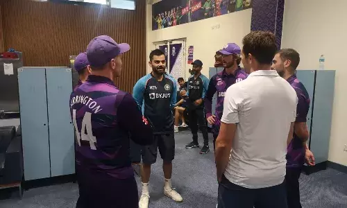 Indian captain Virat Kohli with Scotland players in their dressing room (Source: Scotland Cricket/twiiter)