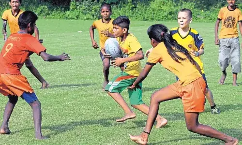 Children playing rugby during a training session at the Calcutta Maidan