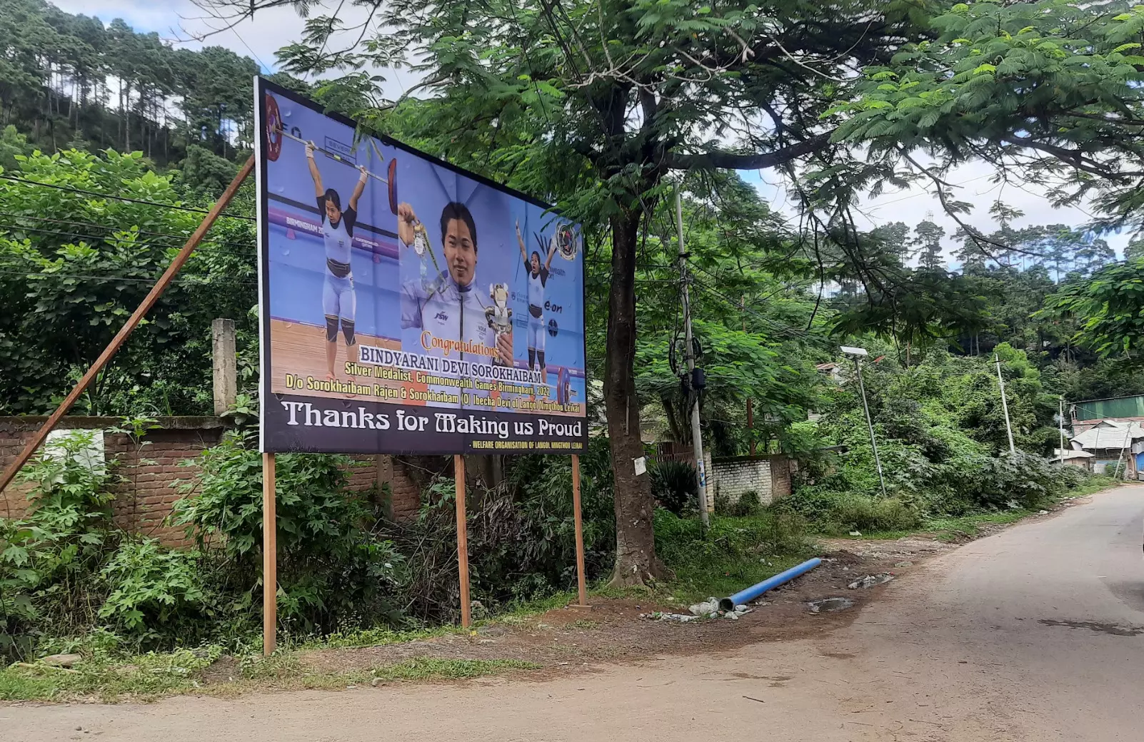 A poster on local hero Bindyarani Devi 500 metres from her home in Langol
