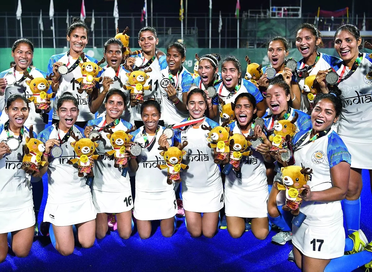 Indian womens hockey team poses for a photograph after winning the silver medal at the 2018 Jakarta Asian Games.