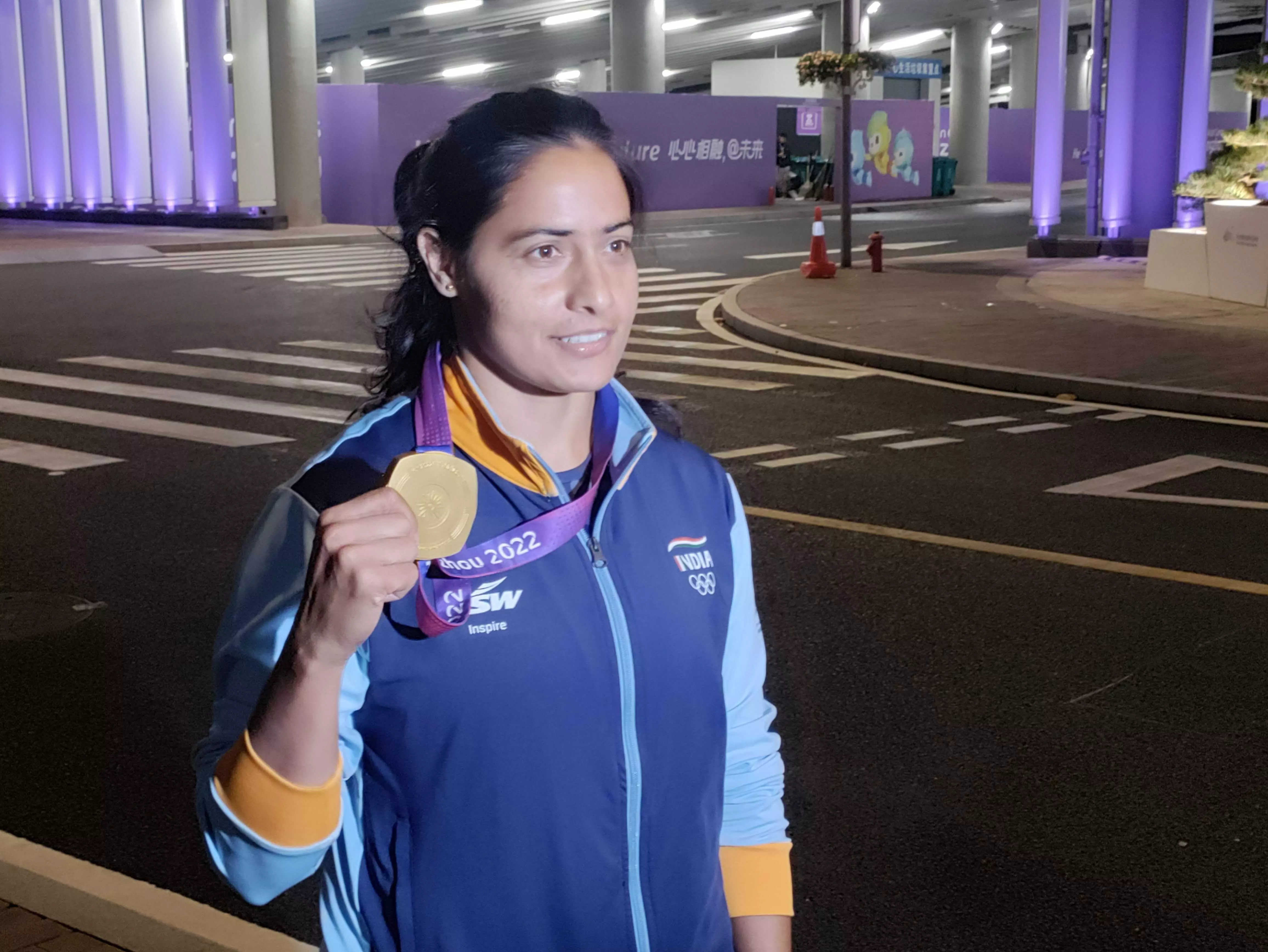 Annu Rani shows off her gold medal outside the Asian Games venue