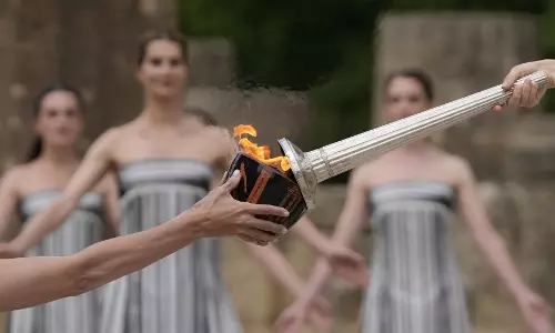 Paris Olympics flame lit at Ancient Olympia despite weather issues