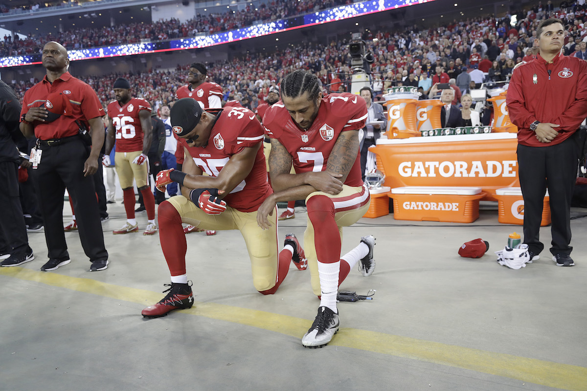 San Francisco 49ers safety Eric Reid (35) and quarterback Colin Kaepernick (7) kneel during the national anthem before an NFL football game 