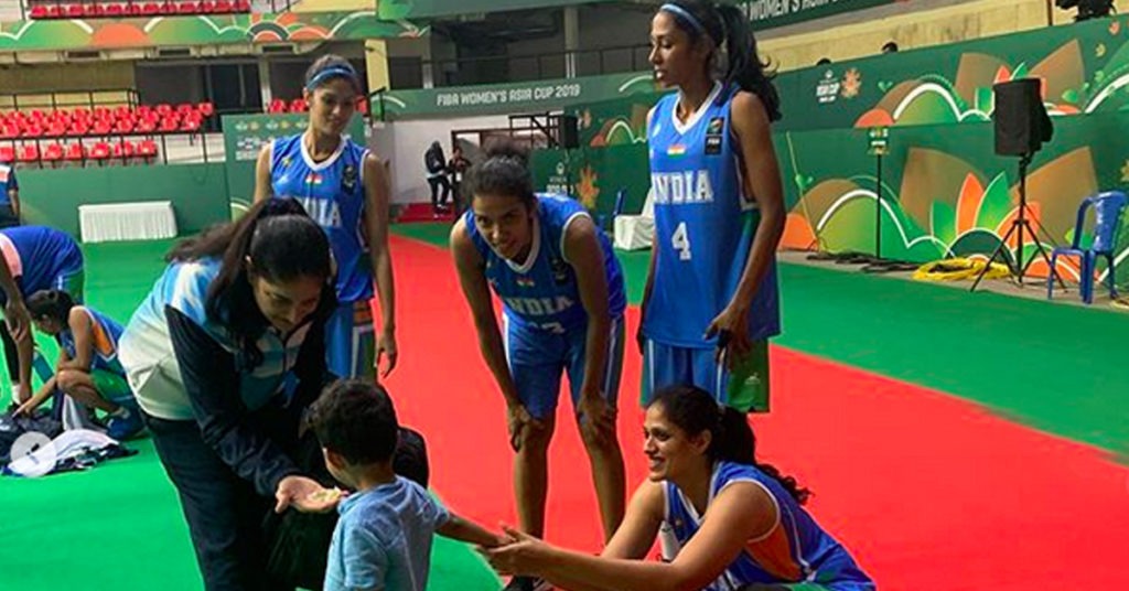 The Indian basketball team at Kanteerava Stadium with Stephy and her son