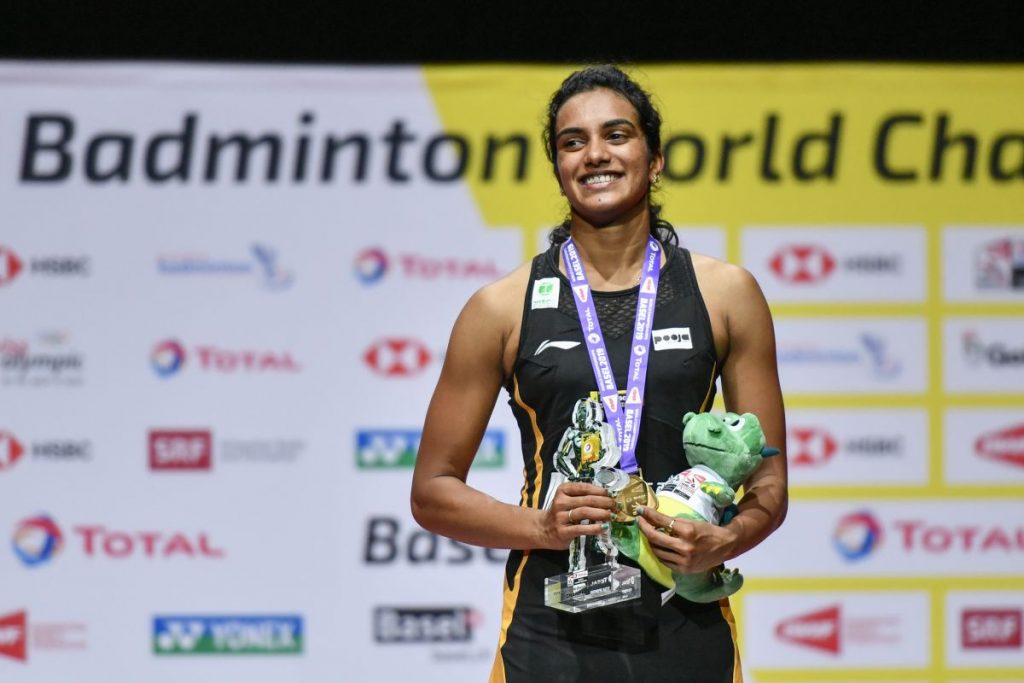First-placed India's Pusarla Venkata Sindhu poses on with the gold medal during the podium cermony after her victory over Japan's Nozomi Okuhara during their women's singles final match at the BWF Badminton World Championships 