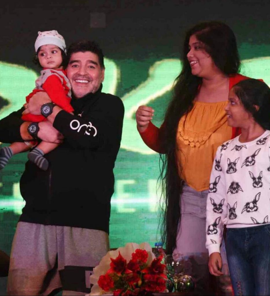 Maradona with Satadru's son Diego in his hand